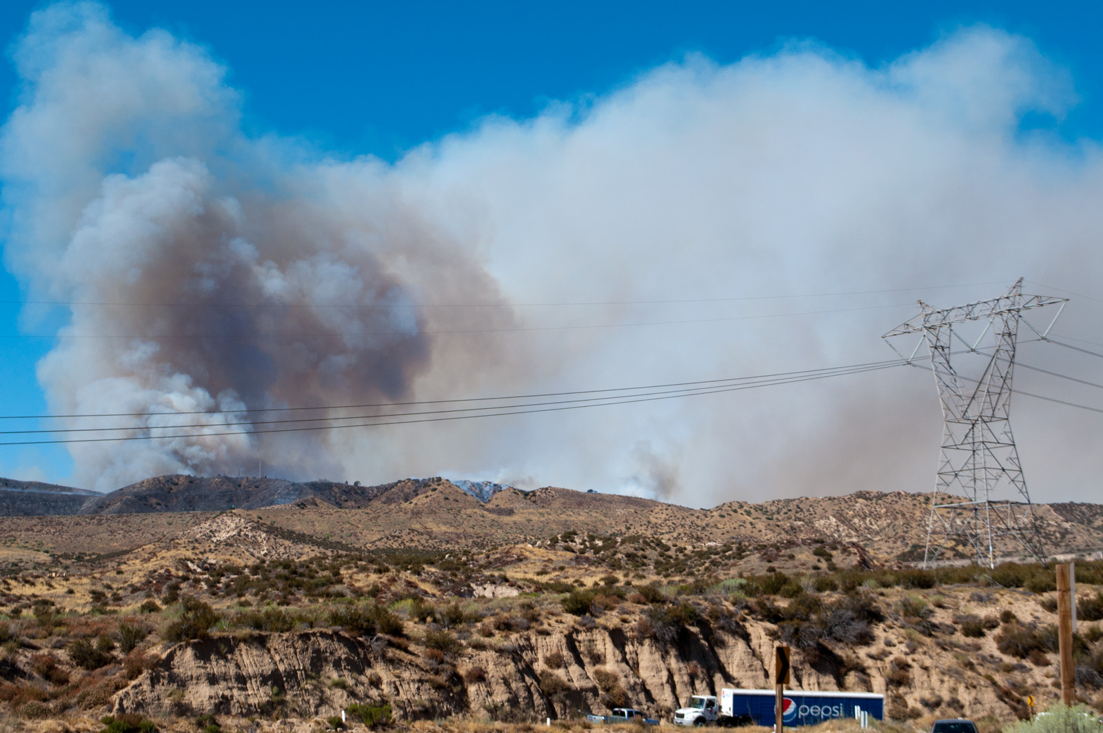 Smoke from a brush fire near transmission lines at Cajon Pass